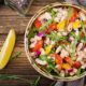 a vibrant bowl of beans and assorted vegetables on a wooden table, ideal for a nutritious diet and meal planning