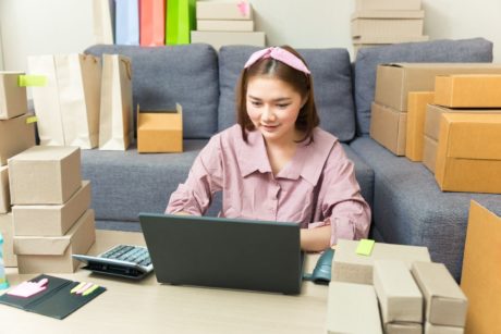 woman with online business product boxes