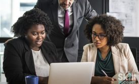 group of business individuals using a laptop to learn business english vocabulary