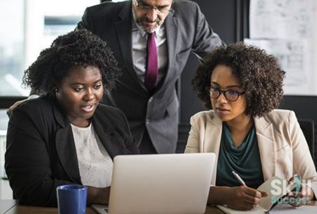group of business individuals using a laptop to learn business english vocabulary
