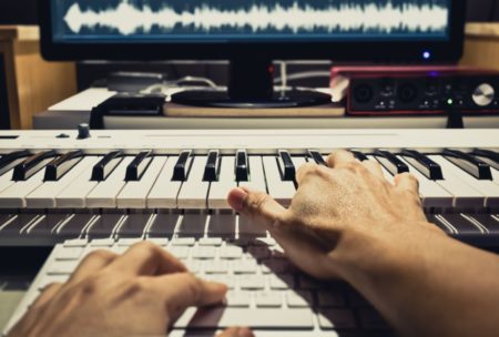 music producer using organ to create soundtrack