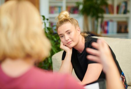 psychotherapist talking to female patient