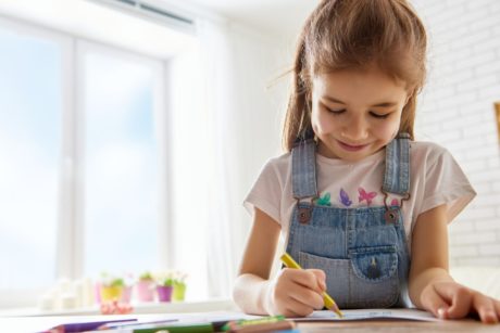 girl smiling and drawing