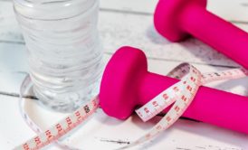 pink dumbbells and measuring tape