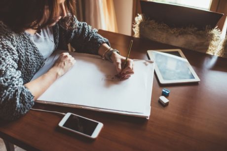 woman drawing with pencil