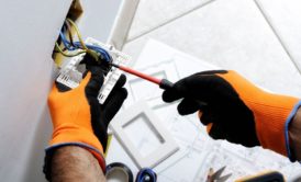 electrician fixing a wall plug