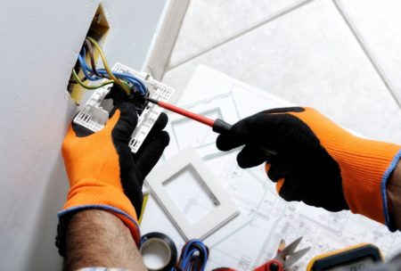 electrician fixing a wall plug