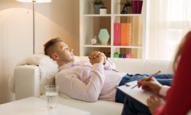 hypnotherapy patient lounging on sofa