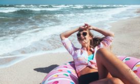 happy woman lounging by the beach