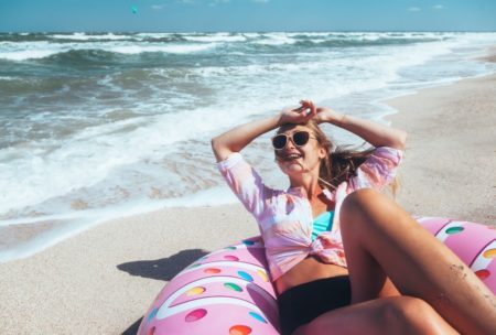 happy woman lounging by the beach