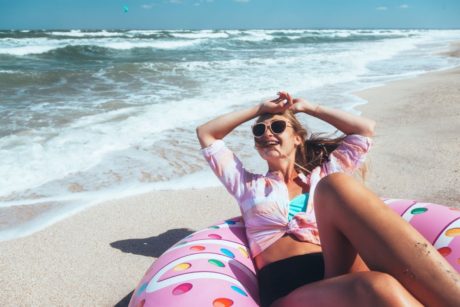 happy woman lounging by the beach