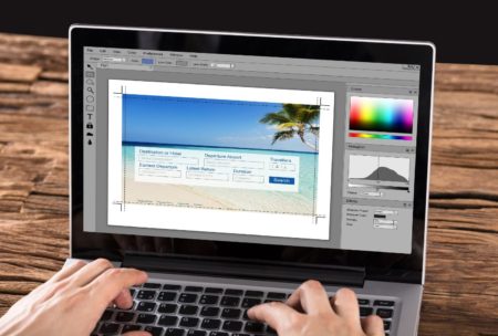 person using photoshop in laptop