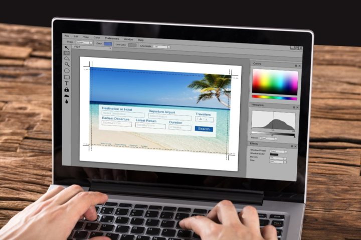person using photoshop in laptop