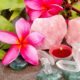 a serene beach scene featuring roses, crystals, and a candle, symbolizing the calming essence of introduction to crystal healing