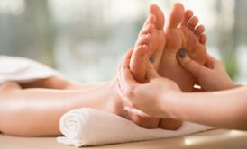 individual receiving a soothing foot massage in a tranquil spa, emphasizing the relaxation offered by reflexology courses online