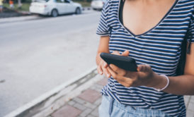 woman trading on smartphone device