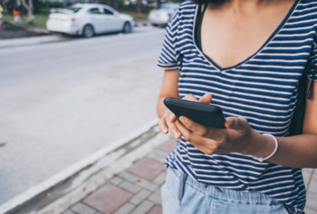 woman trading on smartphone device