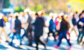 a diverse group of individuals walking along a bustling street, showcasing various disc behavioral styles in their interactions