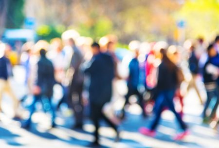 a diverse group of individuals walking along a bustling street, showcasing various disc behavioral styles in their interactions