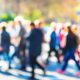 a diverse group of individuals walking along a bustling street, showcasing various disc behavioral styles in their interactions