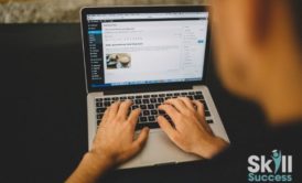 person typing on macbook