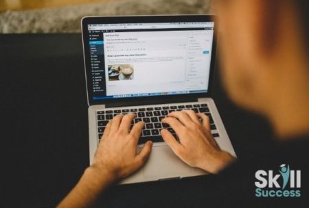 person typing on macbook