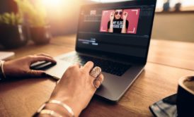 woman editing video in laptop