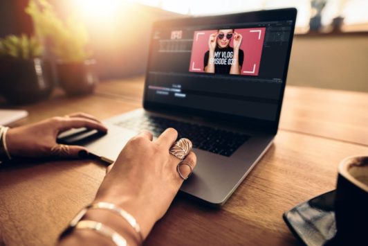 woman editing video in laptop