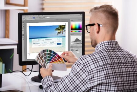 man in front of the computer creating Animation In Adobe Xd