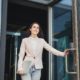 confident woman walking out glass door