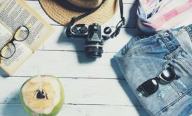 camera book straw hat shades coconut
