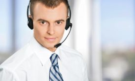 A professional man wearing a headset and tie, representing the concept of hiring virtual assistants