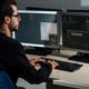 man typing on desktop computer