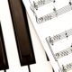 piano keyboard and musical sheets