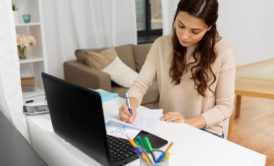 woman writing on paper