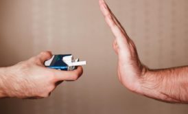 person refusing a pack of cigarettes
