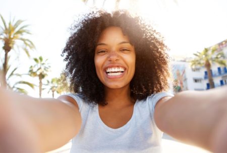 happy woman in white shirt