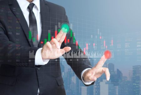 businessman interacting with a virtual stock market display, symbolizing beginners guide to stock market investing