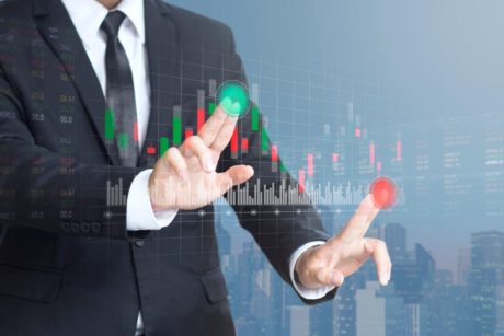 businessman interacting with a virtual stock market display, symbolizing beginners guide to stock market investing