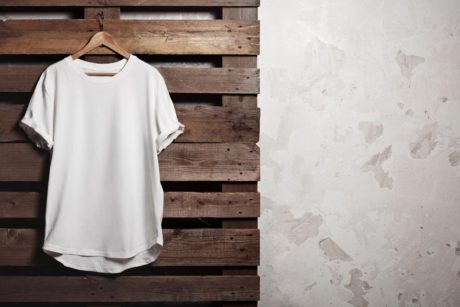 a white t-shirt elegantly hanging on a wooden hanger, representing a stylish option for a t-shirt business