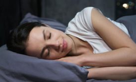a woman sleeping in bed, embodying the essence of restful slumber and effective sleep hacks
