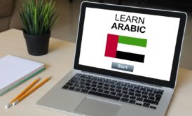 Arabic For Beginners. A digital image showing a laptop with a language learning website open, displaying Arabic text and lessons.