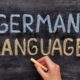 German for Beginners concept with German Language chalked on a blackboard, indicating a start to learning German