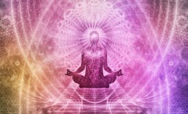 a woman in a lotus position with arms outstretched, embodying peace during a chakra healing course