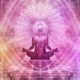a woman in a lotus position with arms outstretched, embodying peace during a chakra healing course