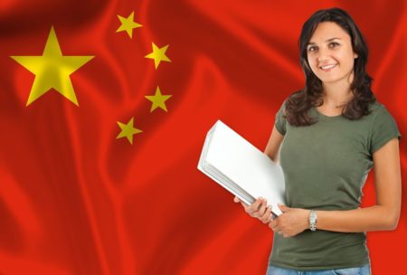 A woman holding a book in front of a Chinese flag, promoting 'earn Chinese For Beginners