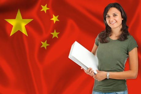 A woman holding a book in front of a Chinese flag, promoting 'earn Chinese For Beginners