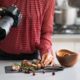 a woman captures a beautifully arranged dish with her camera during a food photography course