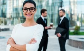 a confident businesswoman in glasses and a suit, representing empowerment in a self-esteem course setting
