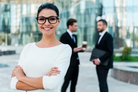 a confident businesswoman in glasses and a suit, representing empowerment in a self-esteem course setting
